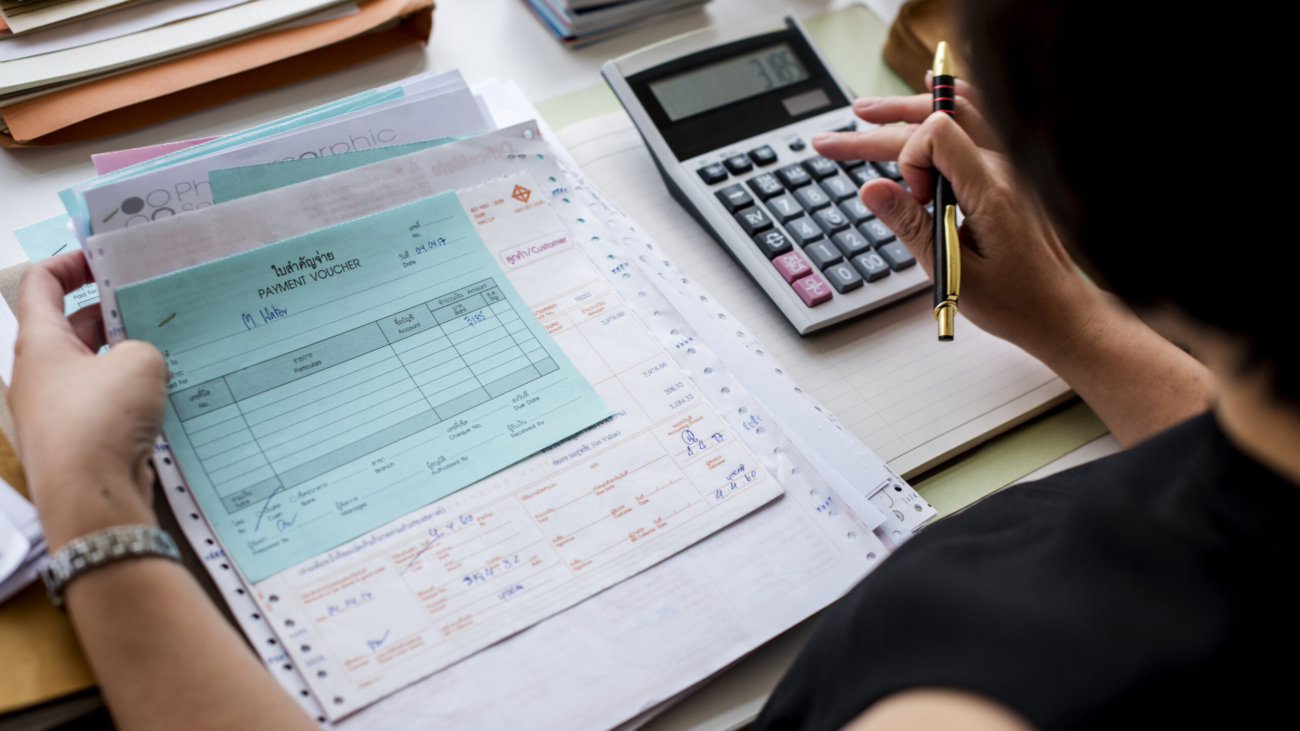 Asian woman working through paperwork