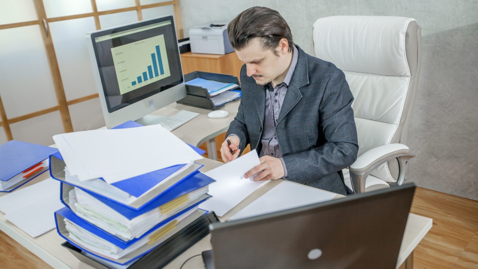A young businessman working from his office - the concept of hard work